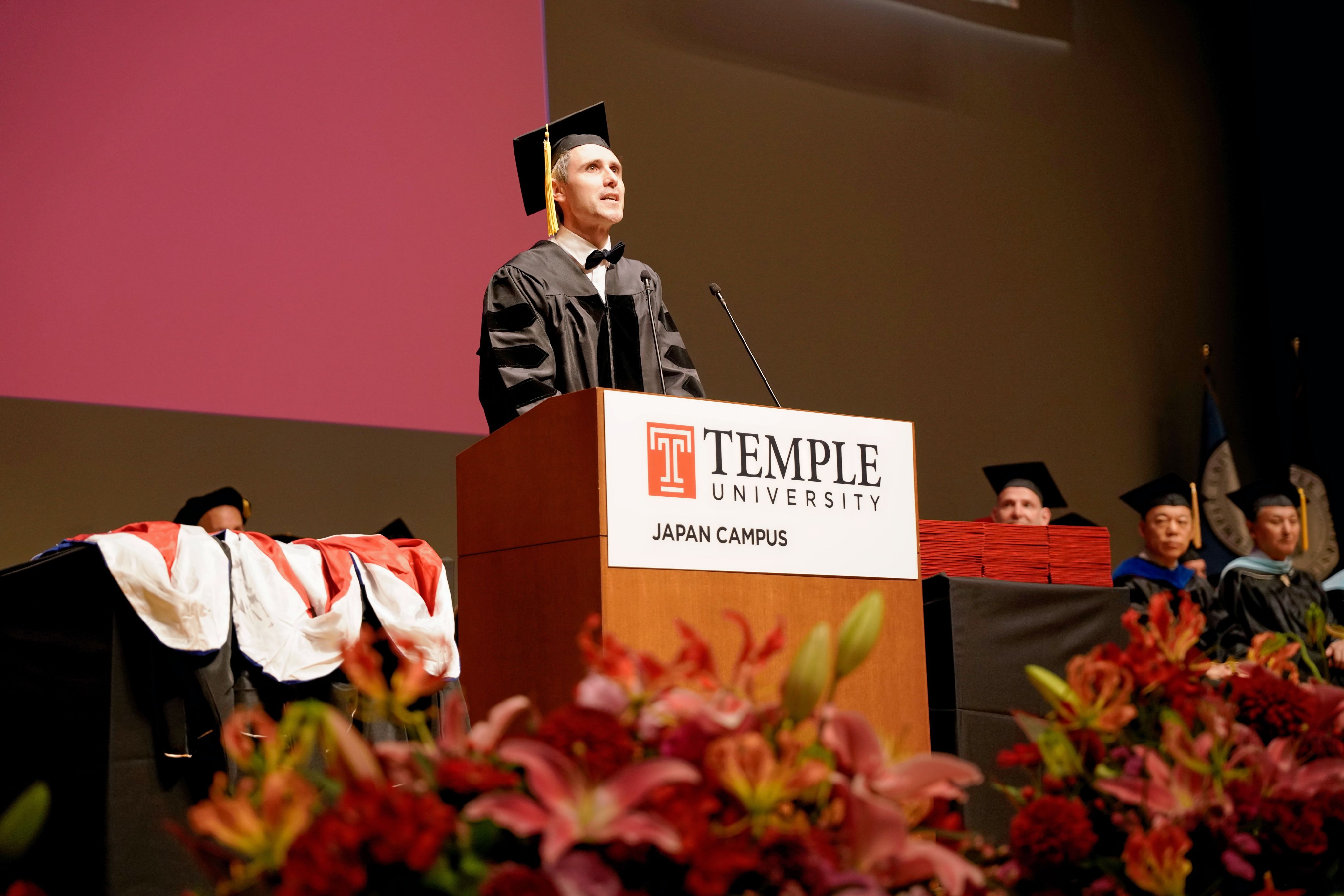 Dr. Bartolome Jose Bazan Rios, one of the graduates, delivers his speech at the podium.