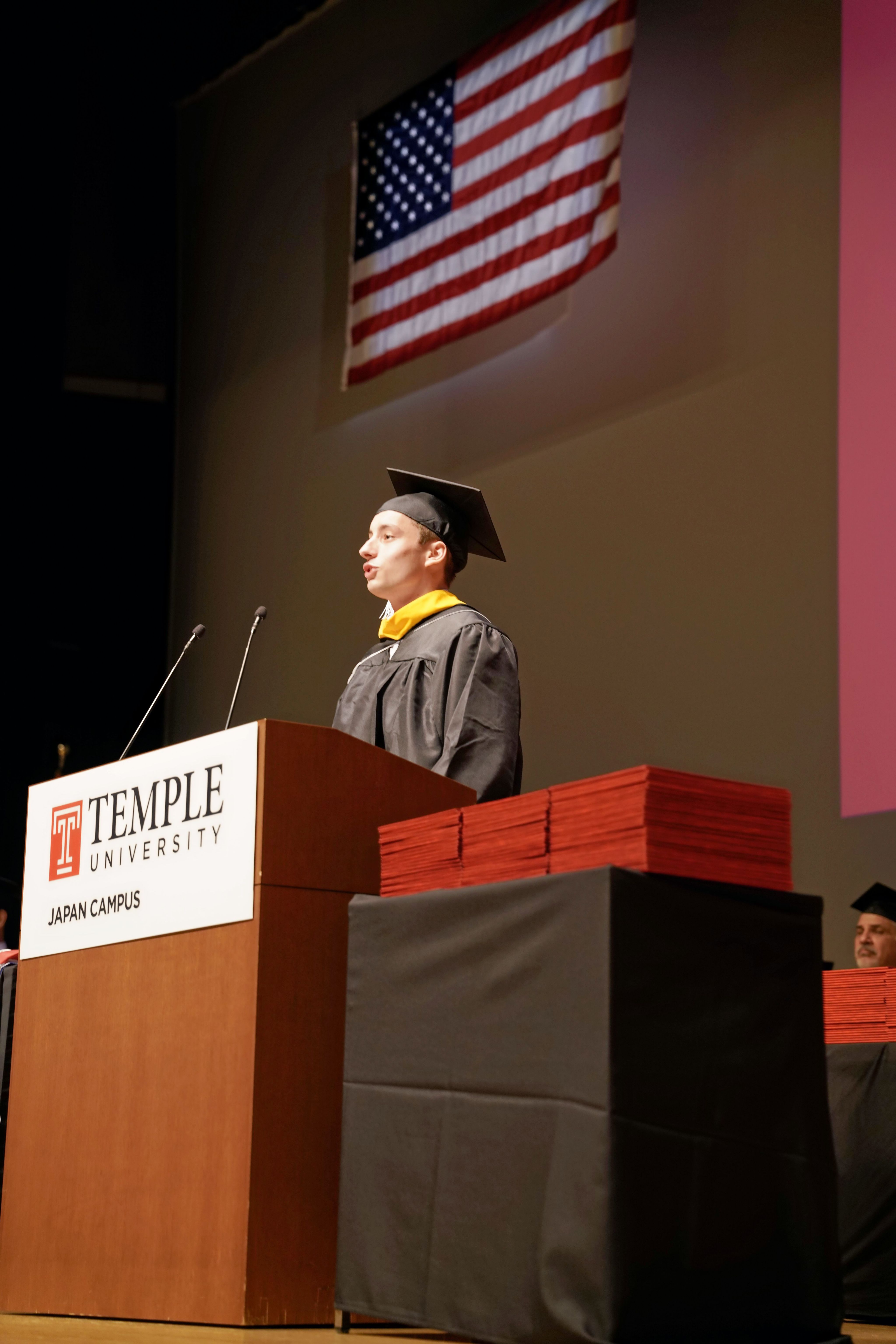 Leonardo D’Amato, one of the graduates, delivers his speech at the podium.