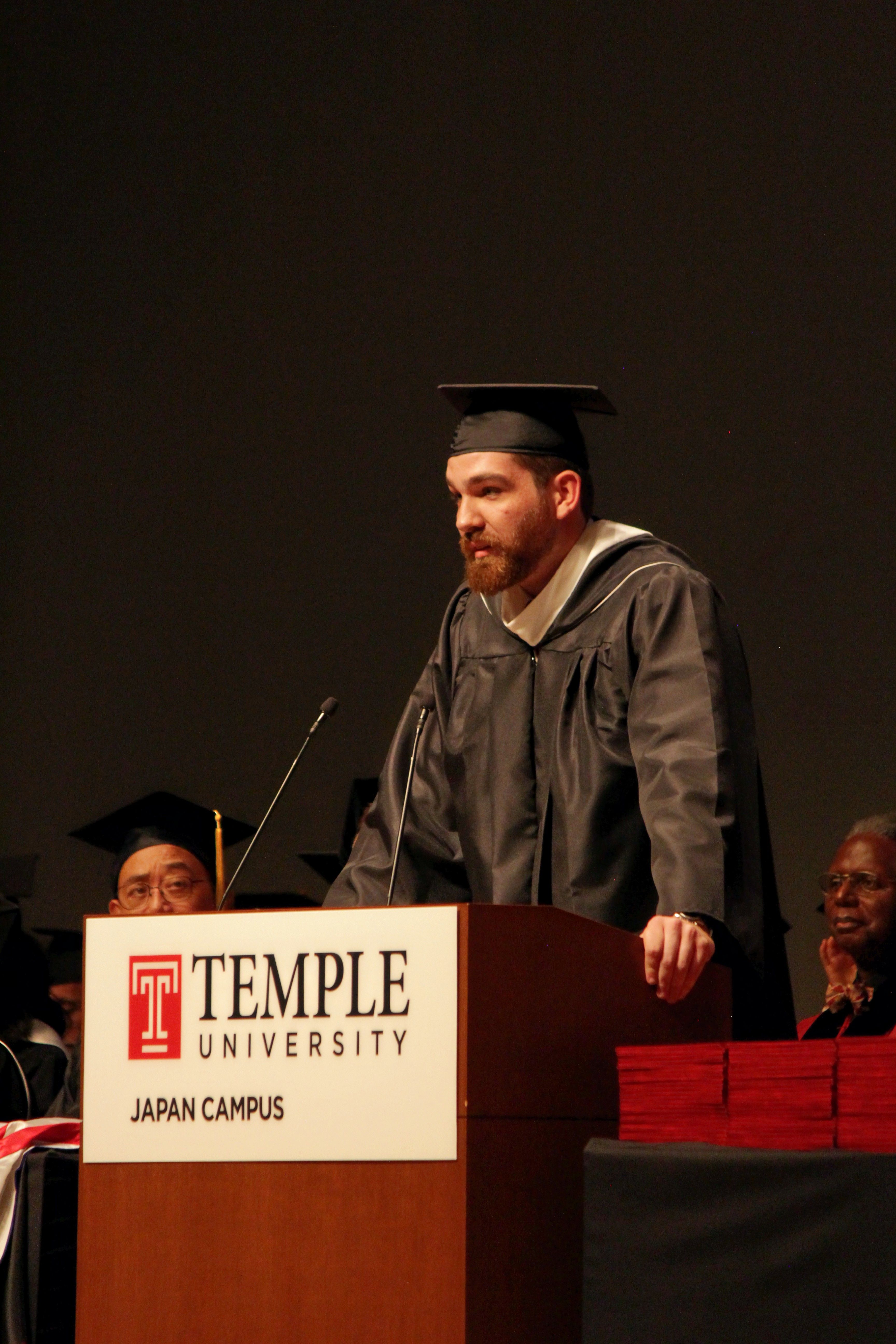 Soren Dickson, one of the graduates, delivers his speech at the podium.